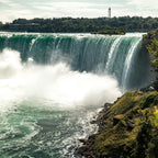 Majestic waterfalls with mist rising from the falls.