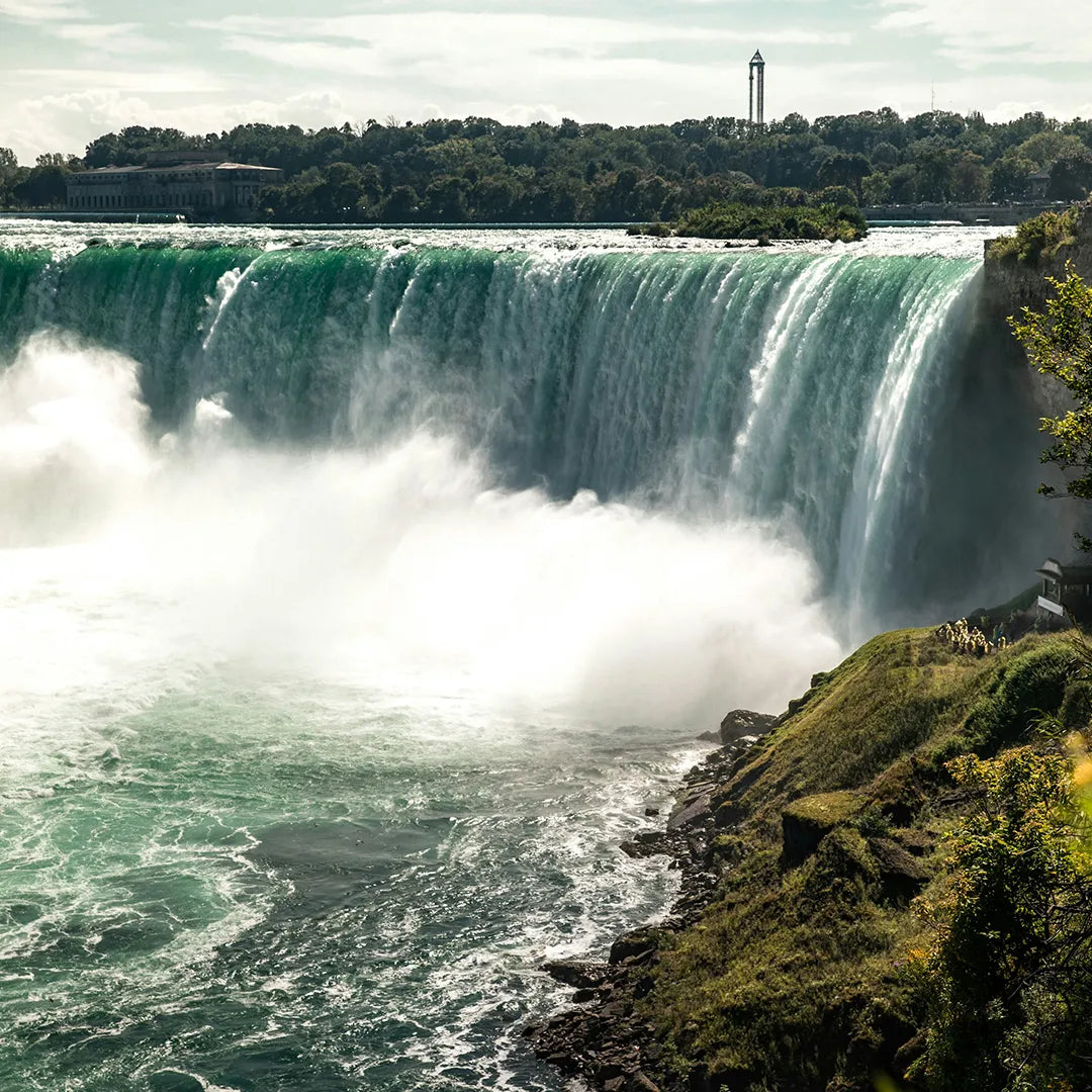 Majestic waterfalls with mist rising from the falls.